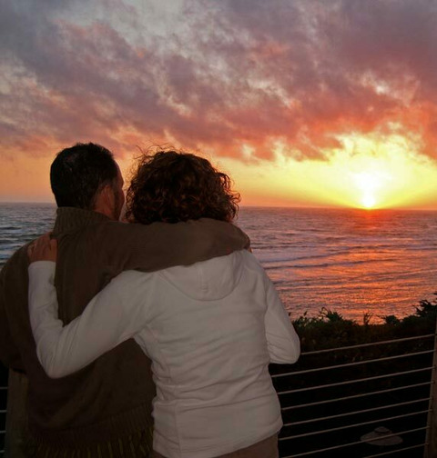 couple enjoying sunset over ocean