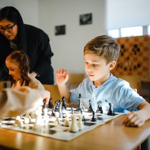 Young boy playing chess